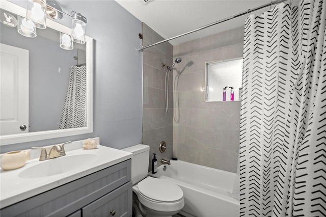 full bathroom featuring shower / bath combo with shower curtain, vanity, and toilet