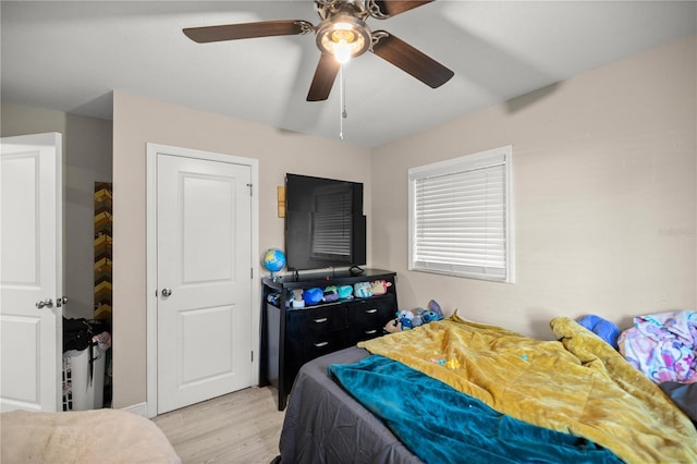 bedroom with light hardwood / wood-style floors and ceiling fan