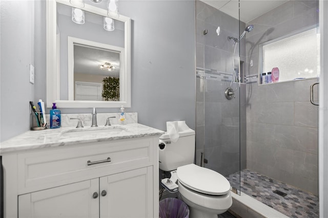 bathroom featuring vanity, an enclosed shower, and toilet