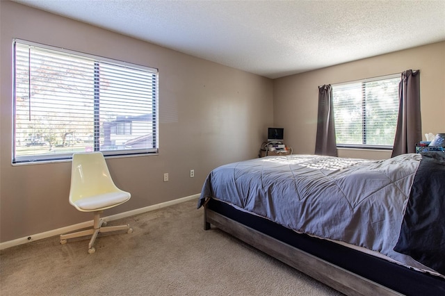 bedroom featuring carpet flooring and a textured ceiling