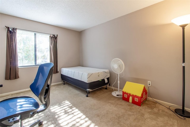 bedroom with light carpet and a textured ceiling