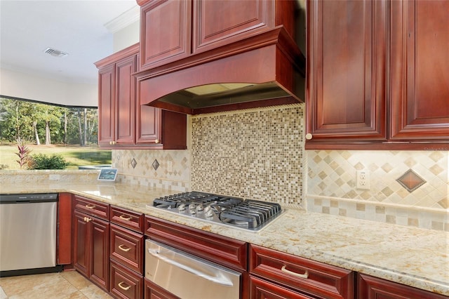 kitchen with backsplash, light stone countertops, premium range hood, and stainless steel appliances