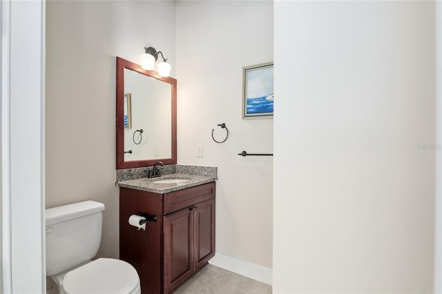 bathroom featuring tile patterned floors, toilet, and vanity