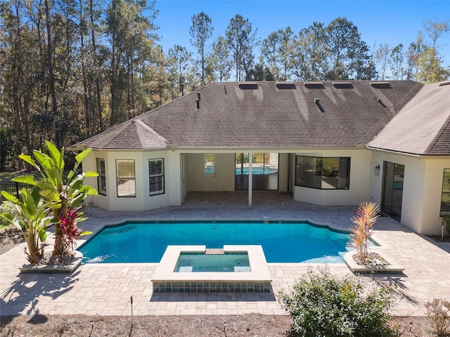 view of pool featuring an in ground hot tub and a patio