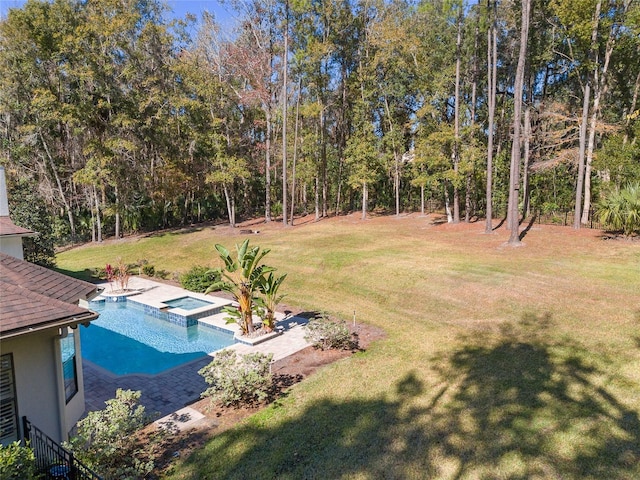 exterior space with an in ground hot tub and a lawn