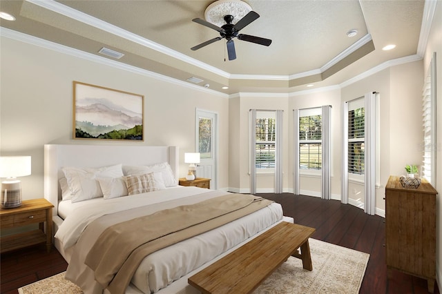 bedroom featuring ceiling fan, hardwood / wood-style flooring, ornamental molding, and a raised ceiling