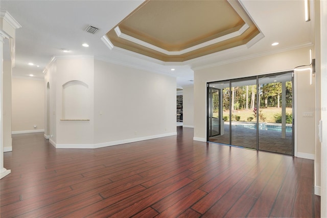 unfurnished room featuring dark hardwood / wood-style flooring, crown molding, and a tray ceiling