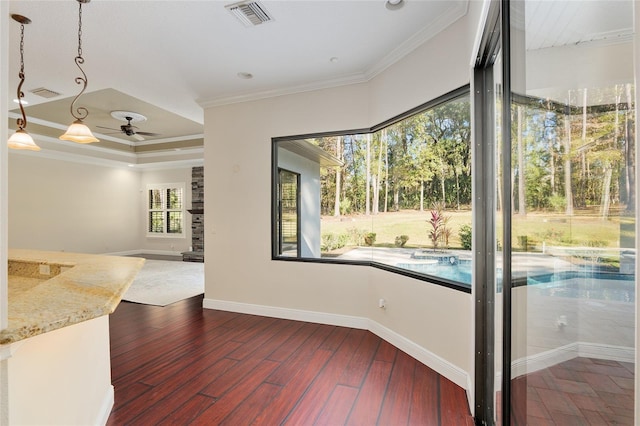 interior space with ceiling fan, a healthy amount of sunlight, and ornamental molding