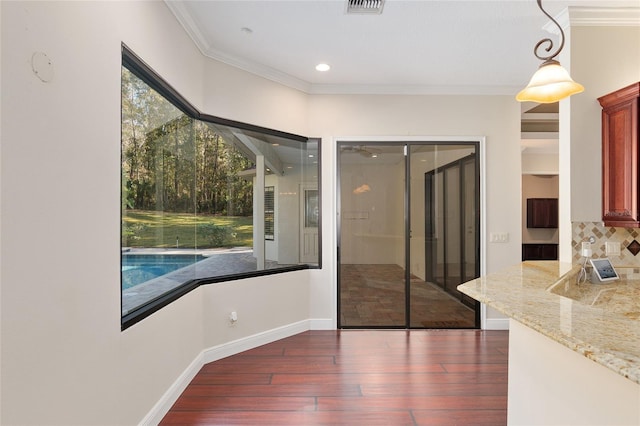 interior space featuring dark wood-type flooring and crown molding