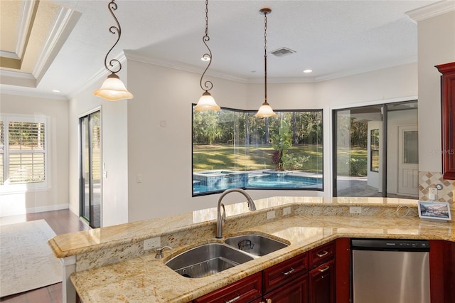 kitchen featuring sink, pendant lighting, dishwasher, and ornamental molding