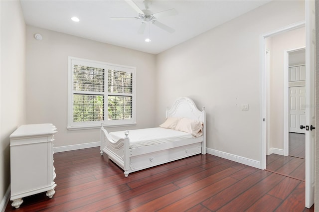 bedroom with ceiling fan and dark wood-type flooring