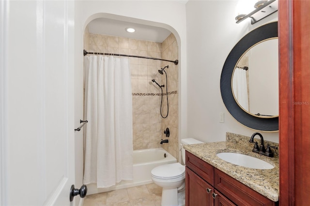 full bathroom featuring tile patterned flooring, toilet, vanity, and shower / tub combo with curtain