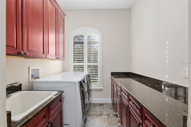 washroom featuring cabinets, a wealth of natural light, washer and clothes dryer, and sink