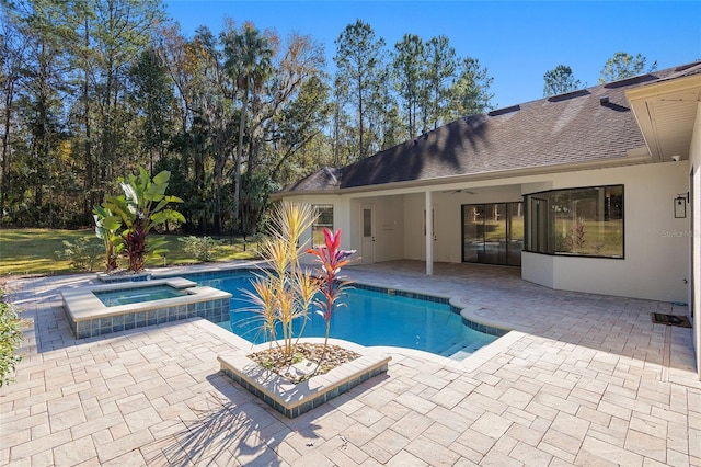 view of pool with a patio area and an in ground hot tub