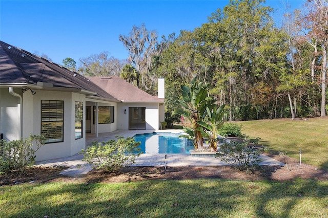 view of swimming pool featuring a yard and a patio