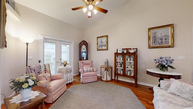 sitting room with french doors, hardwood / wood-style floors, vaulted ceiling, and ceiling fan