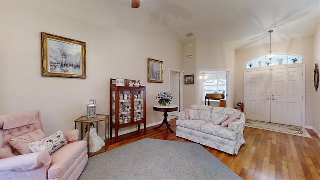 living room with ceiling fan and wood-type flooring