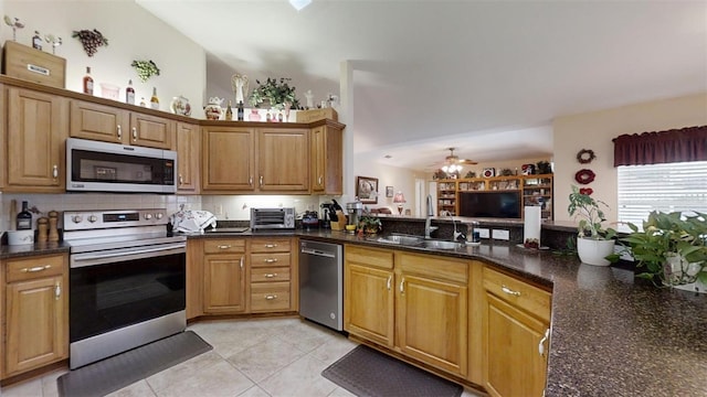 kitchen featuring sink, ceiling fan, light tile patterned floors, backsplash, and appliances with stainless steel finishes