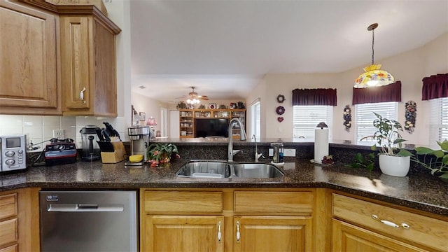 kitchen with sink, dishwasher, ceiling fan, decorative backsplash, and hanging light fixtures