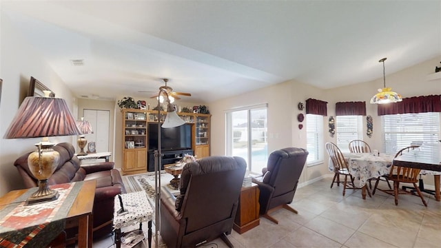 living room with vaulted ceiling, light tile patterned flooring, and ceiling fan