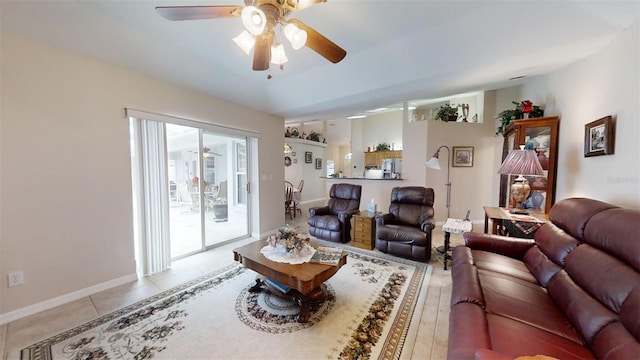 tiled living room featuring ceiling fan