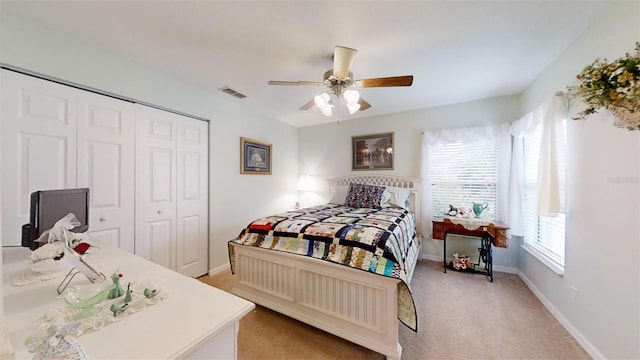 carpeted bedroom with a closet and ceiling fan