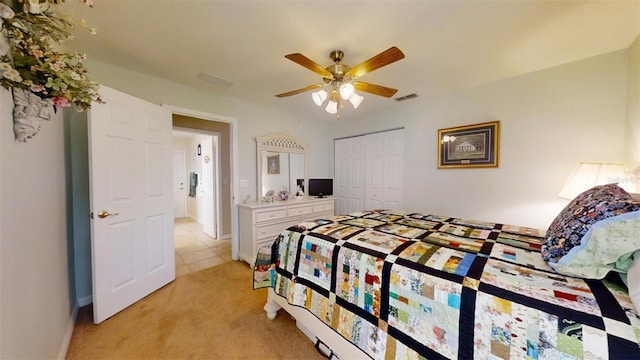 bedroom featuring light carpet, a closet, and ceiling fan