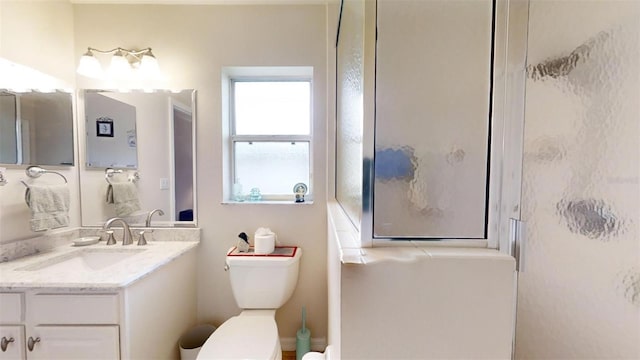 bathroom with toilet, vanity, and walk in shower