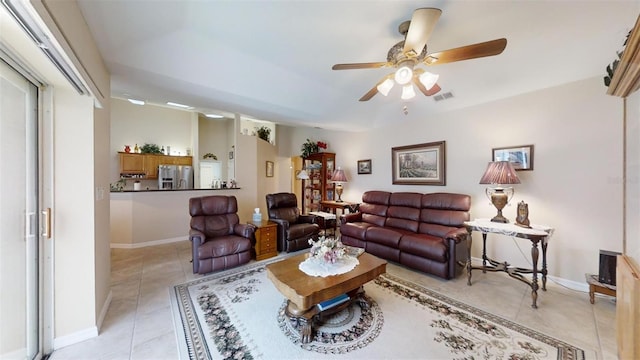 tiled living room featuring ceiling fan