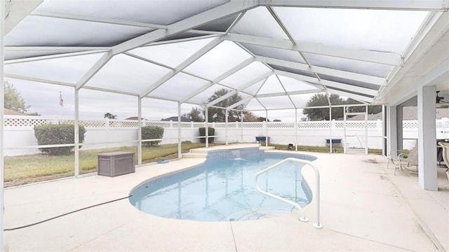 view of swimming pool featuring a lanai and a patio area