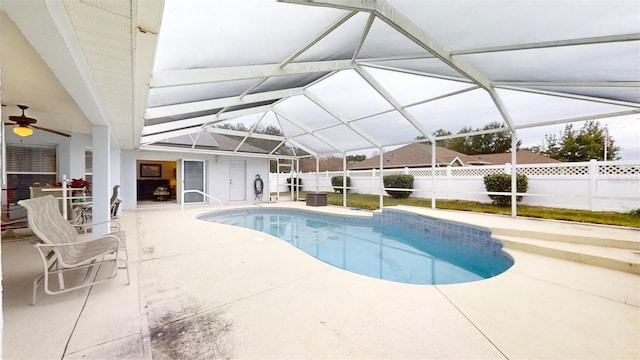 view of swimming pool featuring a lanai, ceiling fan, and a patio area