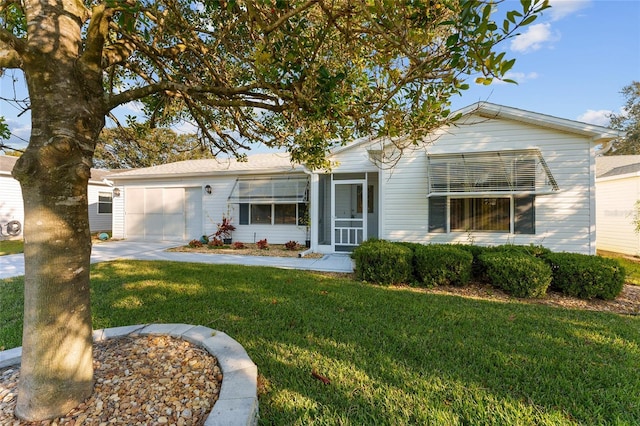 ranch-style home featuring a front yard and a garage