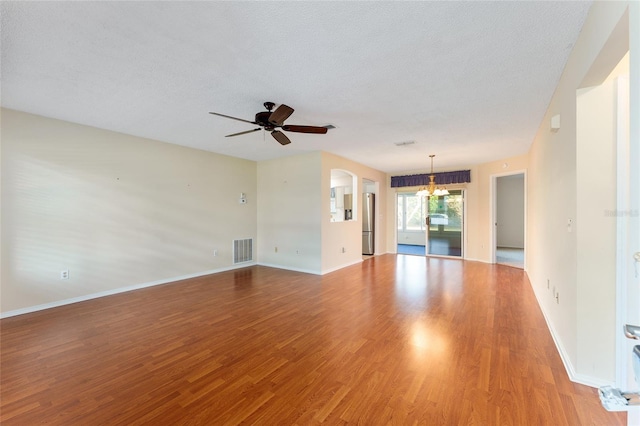 unfurnished living room with ceiling fan, a textured ceiling, and hardwood / wood-style flooring