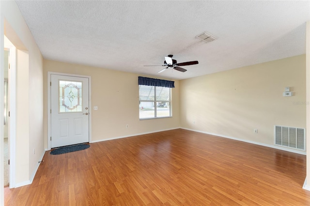 foyer with a textured ceiling, hardwood / wood-style flooring, and ceiling fan