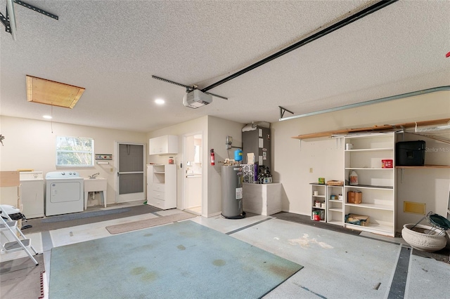 garage featuring washer and dryer, electric water heater, a garage door opener, and sink