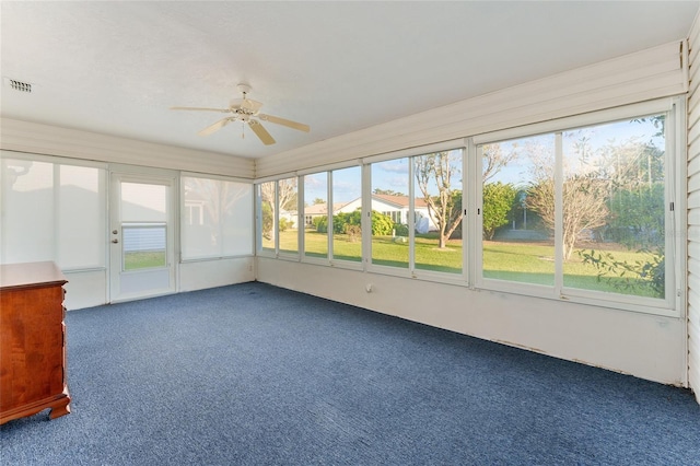 unfurnished sunroom with ceiling fan