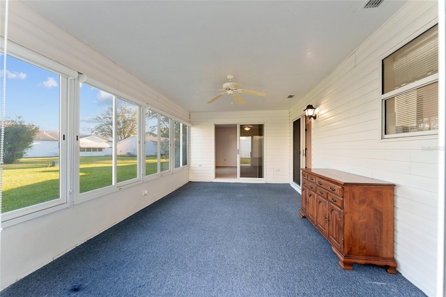 unfurnished sunroom with plenty of natural light and ceiling fan