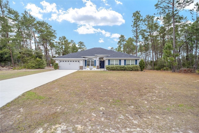 ranch-style house featuring a front lawn and a garage