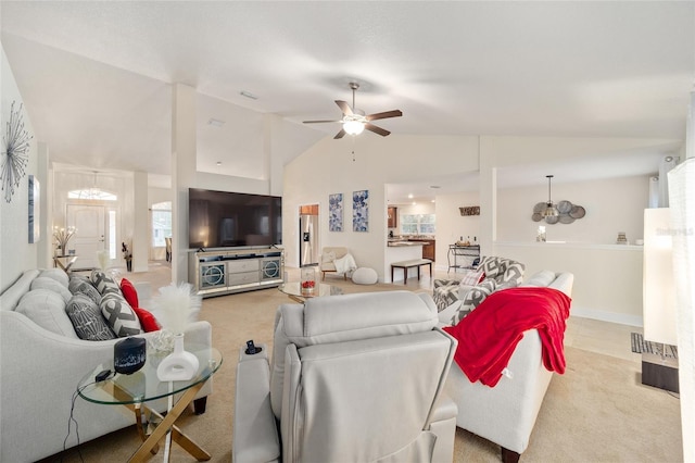 living room with light colored carpet, vaulted ceiling, and ceiling fan with notable chandelier