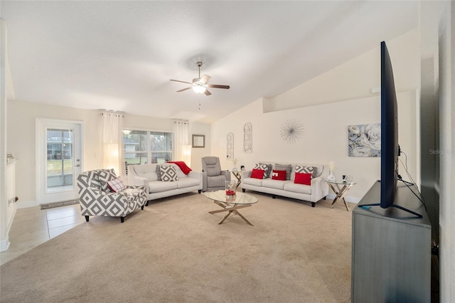 carpeted living room with ceiling fan and vaulted ceiling