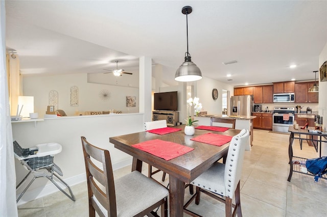 dining room featuring ceiling fan and light tile patterned flooring