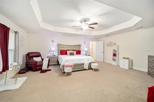 bedroom featuring ceiling fan, crown molding, light carpet, and a raised ceiling