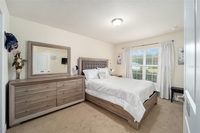 carpeted bedroom with a textured ceiling