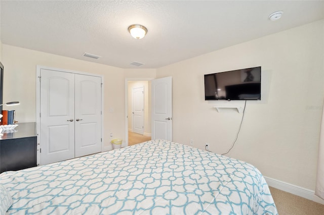 carpeted bedroom featuring a closet