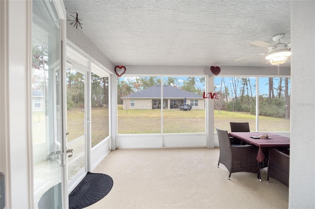 sunroom featuring ceiling fan