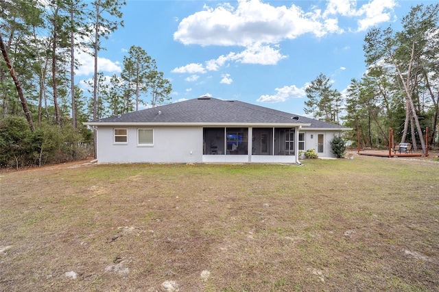 back of property with a yard and a sunroom