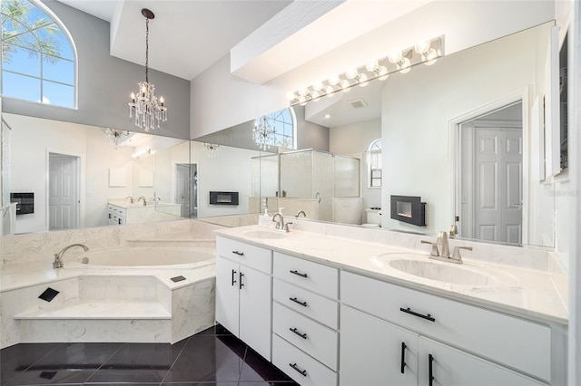 bathroom with a chandelier, shower with separate bathtub, vanity, and tile patterned floors