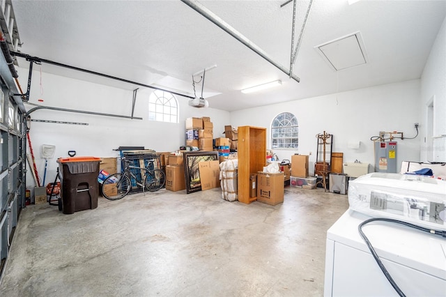 garage with washer / clothes dryer, a garage door opener, and water heater