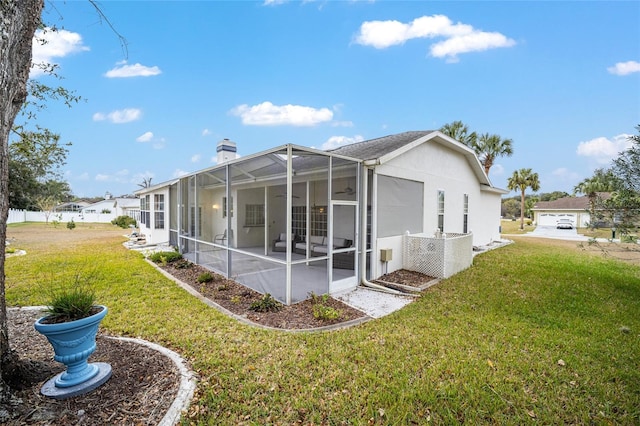 view of side of property featuring a patio, a lanai, and a lawn