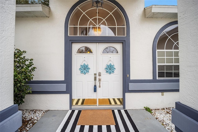 doorway to property with stucco siding